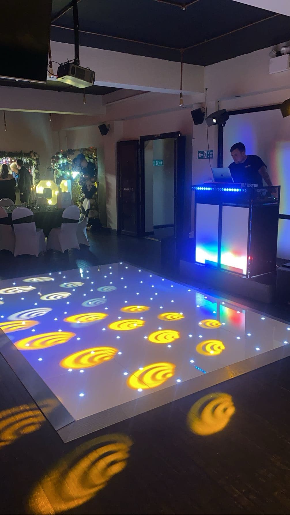 White starlit LED dancefloor with DJ booth at Gracy's