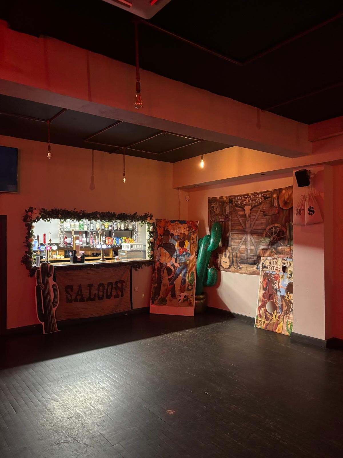 Themed party setup at Gracy's with saloon banner across the private bar